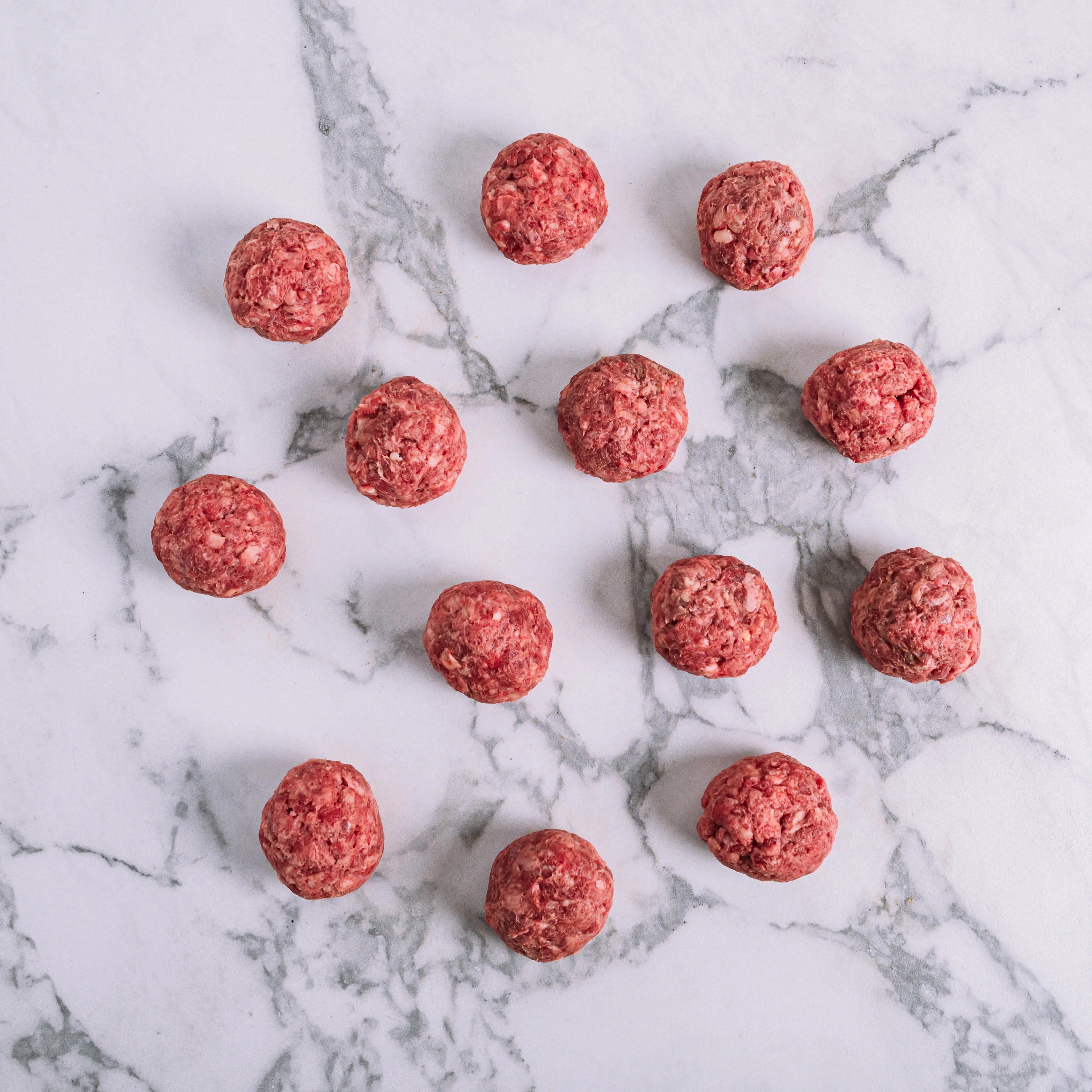 Fresh pre-rolled ground beef balls from Santiago Beef, perfectly portioned for smash burgers