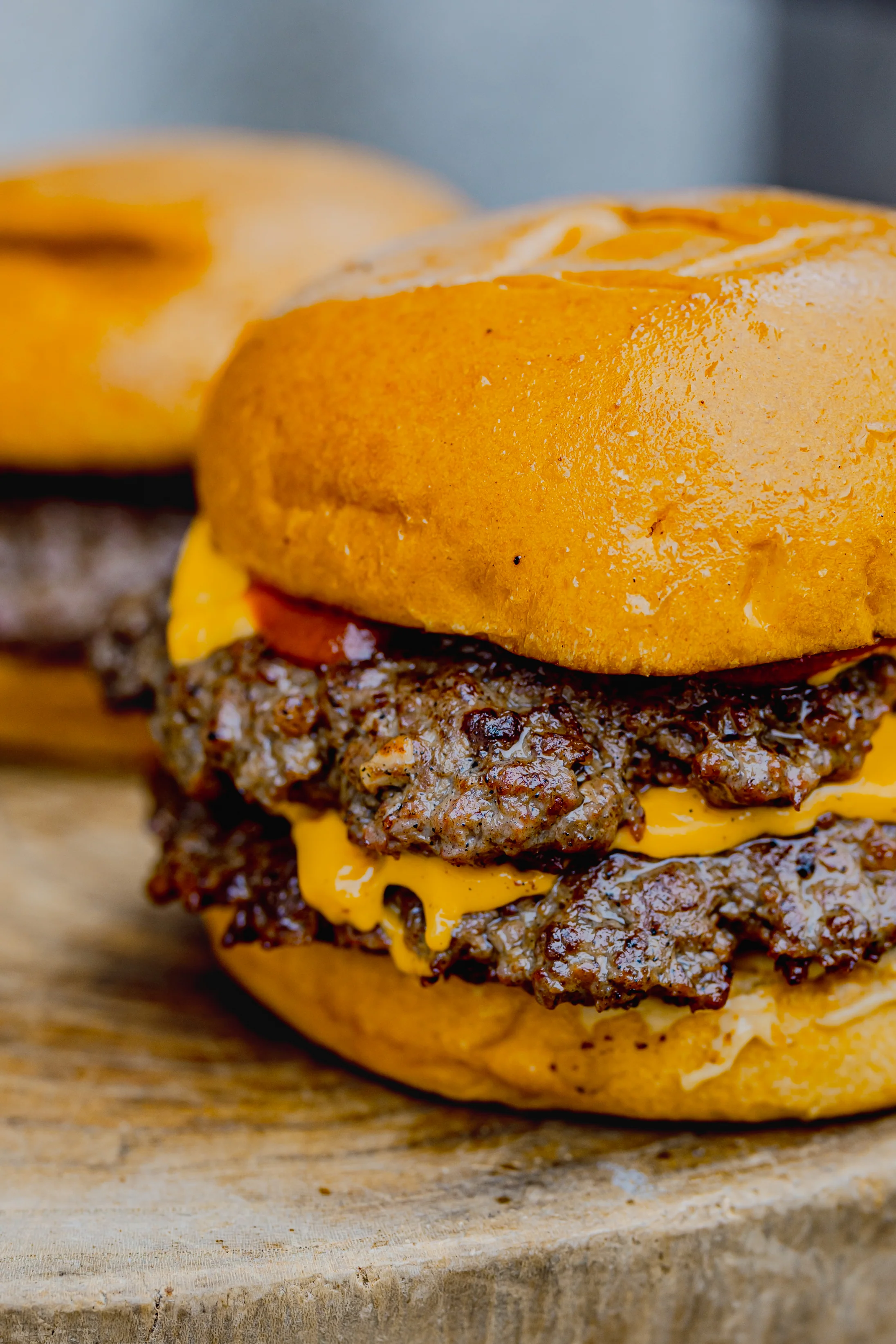Multi-patty smash burger with perfect char and melted cheese made with Santiago Beef